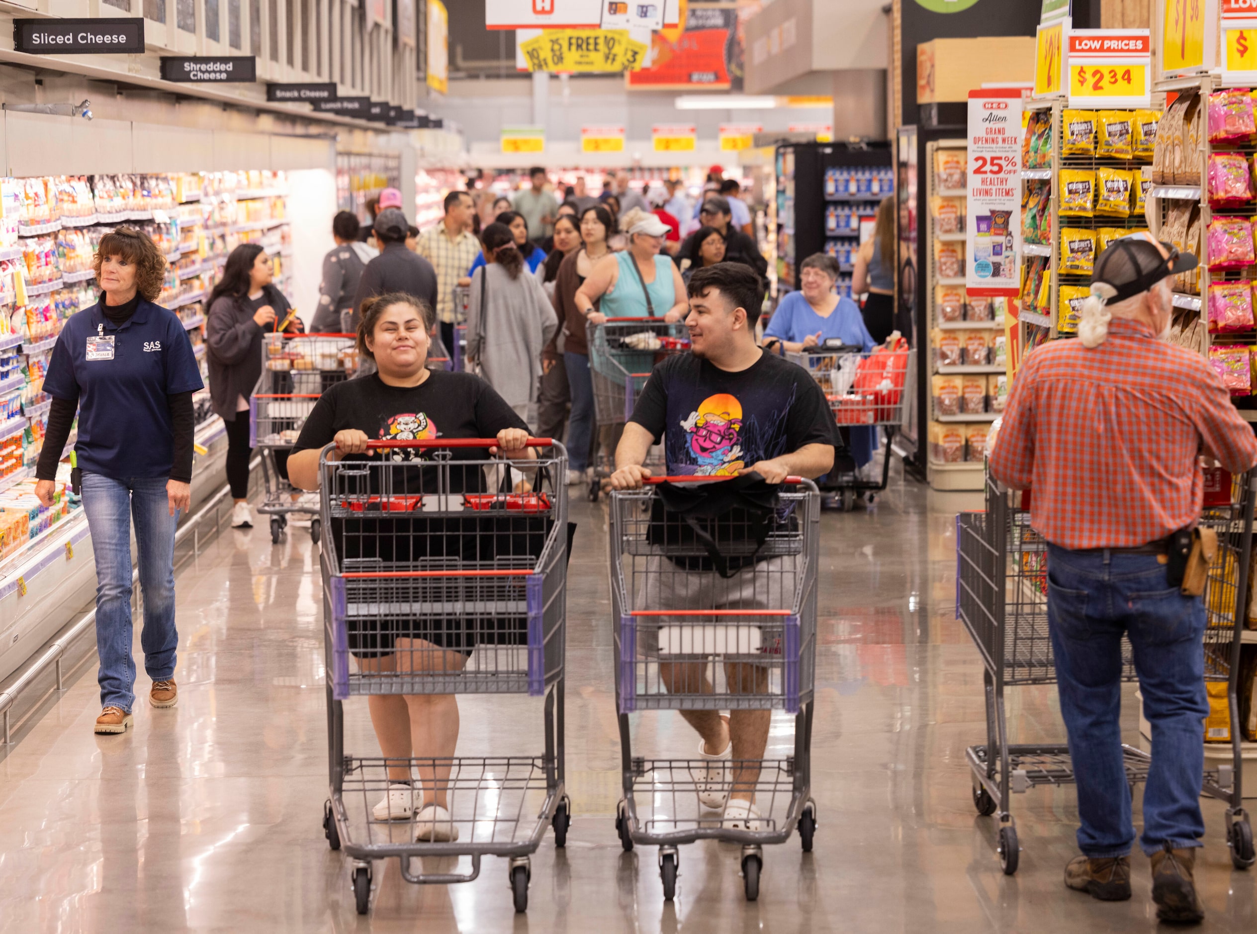 Customers Jennifer Lopez (center left) and Oscar Morales (center right) of Allen shop during...