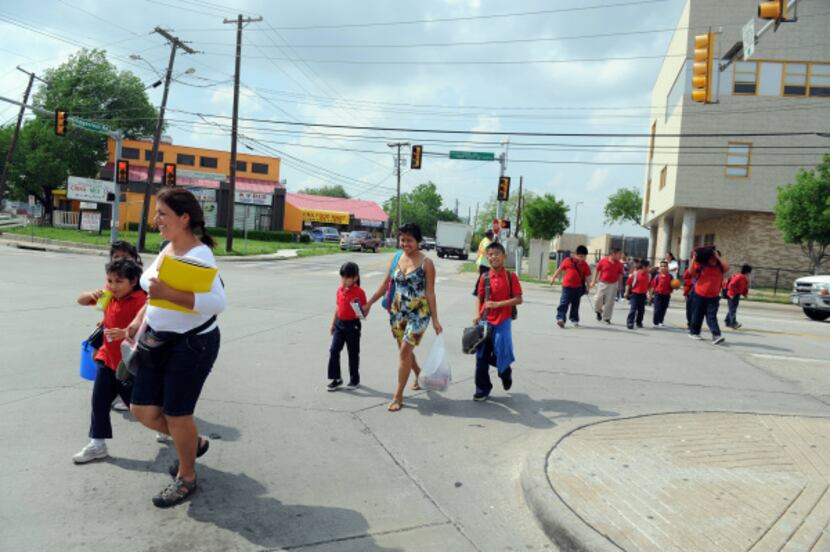 Students from Jack Lowe Sr. Elementary cross the intersection that gives the Five Points...