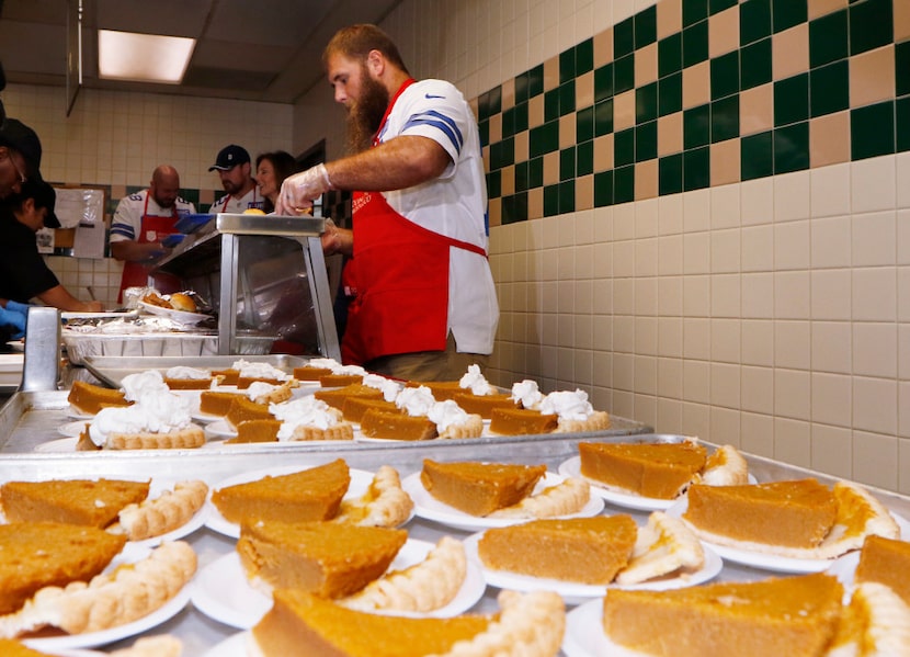 Dallas Cowboys center Travis Frederick helped serve early Thanksgiving dinners with others...