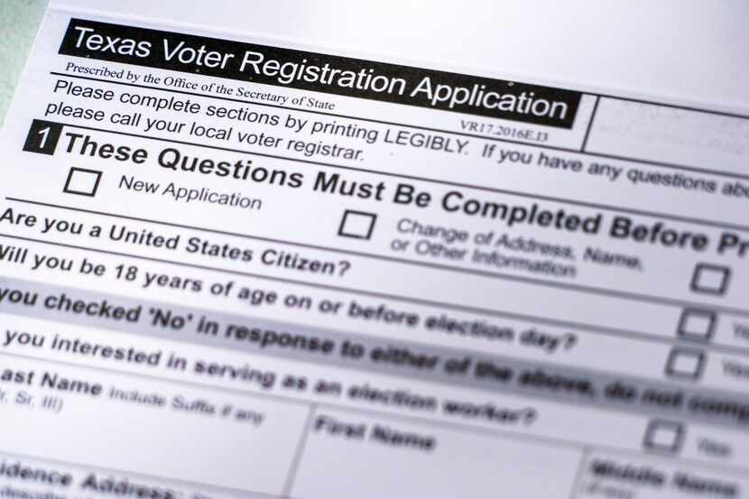 Voter registration materials seen at a volunteer registration table during the Arlington...
