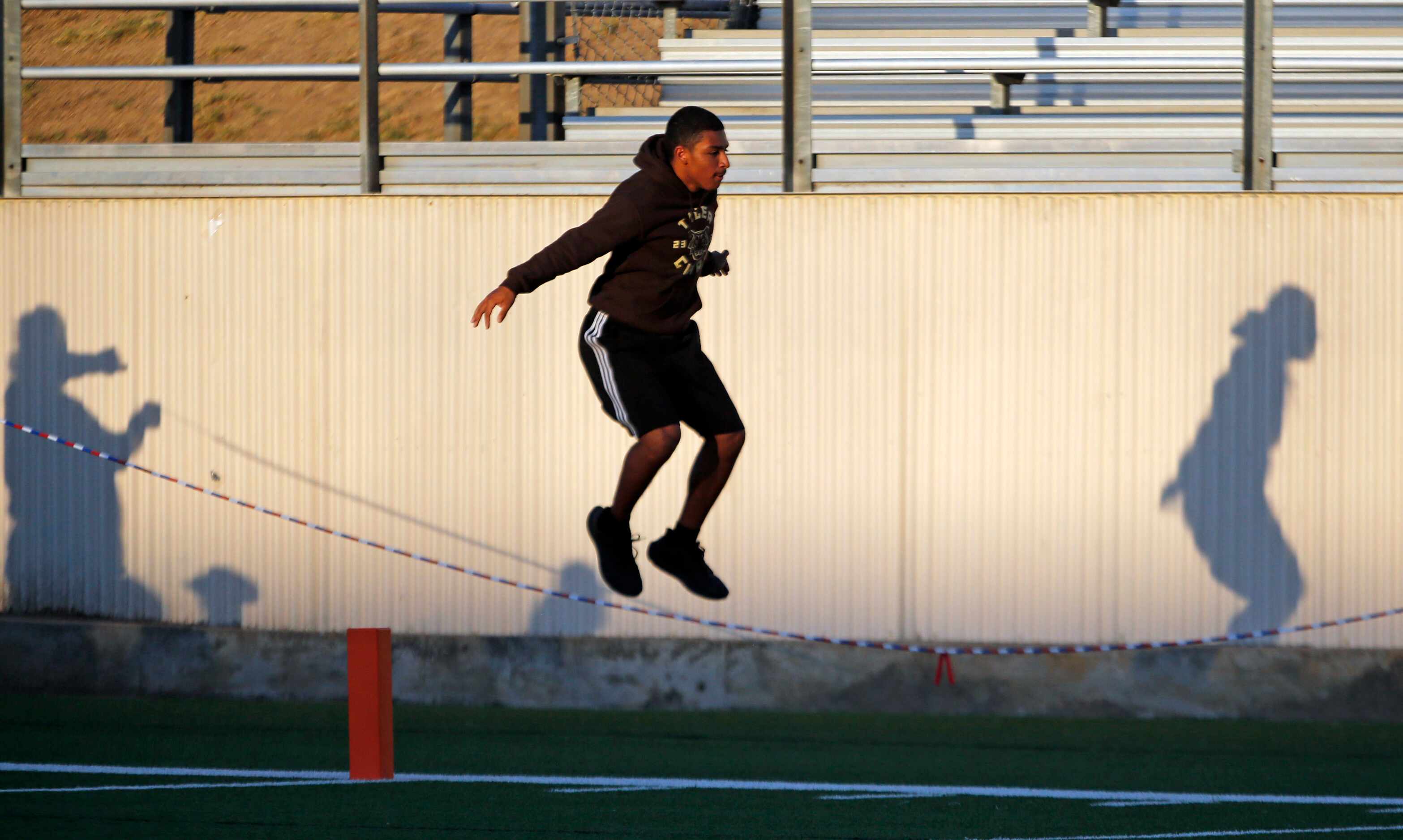 An Irving high fans jumps rope on the sideline before the start of the first half of a high...