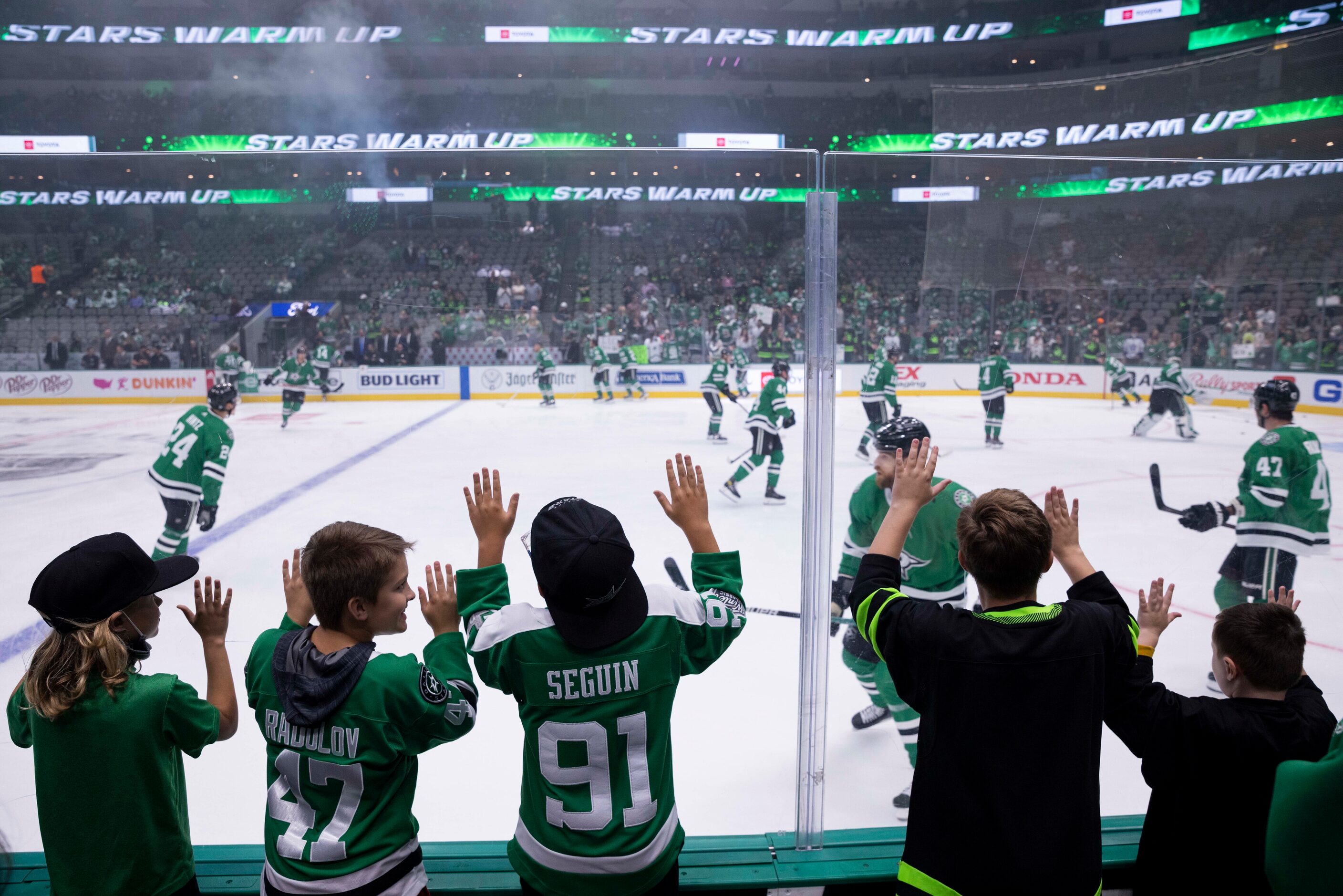 Young fans watch players warmup before the start of Dallas Stars home opener against the Los...