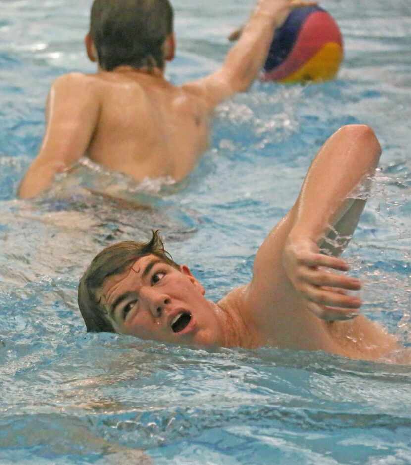 
Josiah Panak, 15, swims after the ball during practice. He participates with a club team in...