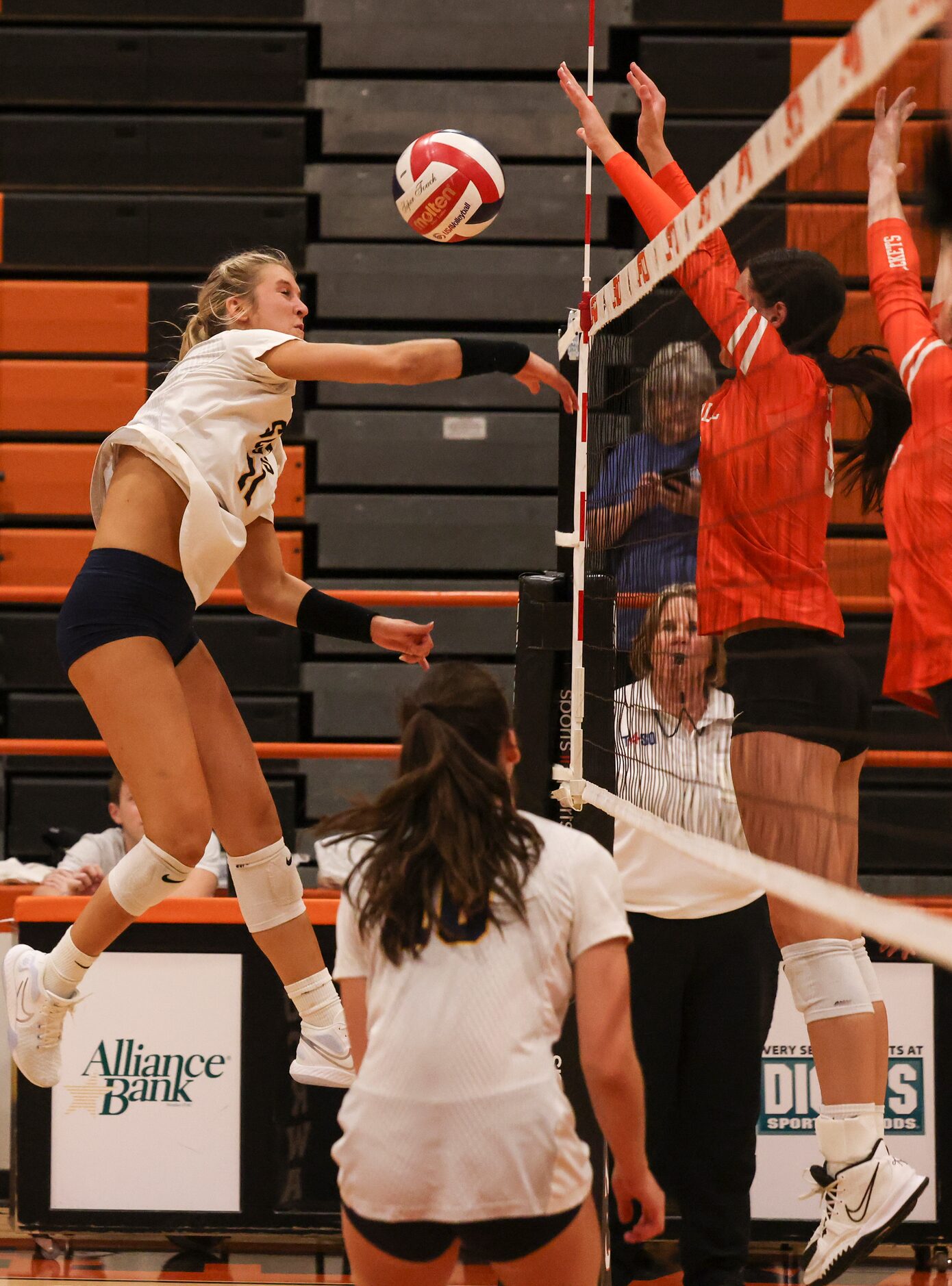 Highland Park High School’s Sydney Breon’s spike is blocked by Rockwall High School during...