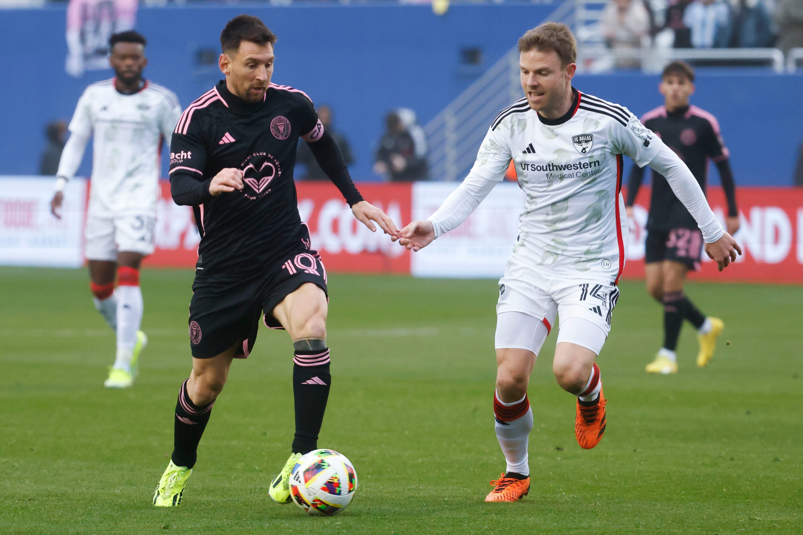 Inter Miami forward Lionel Messi (left) runs past FC Dallas midfielder Asier Illarramendi...