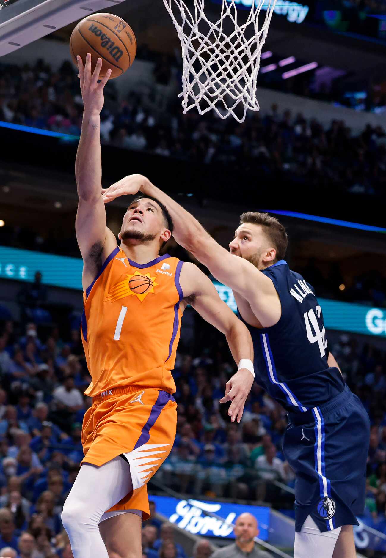 Dallas Mavericks forward Maxi Kleber (42) coems down hard on Phoenix Suns guard Devin Booker...