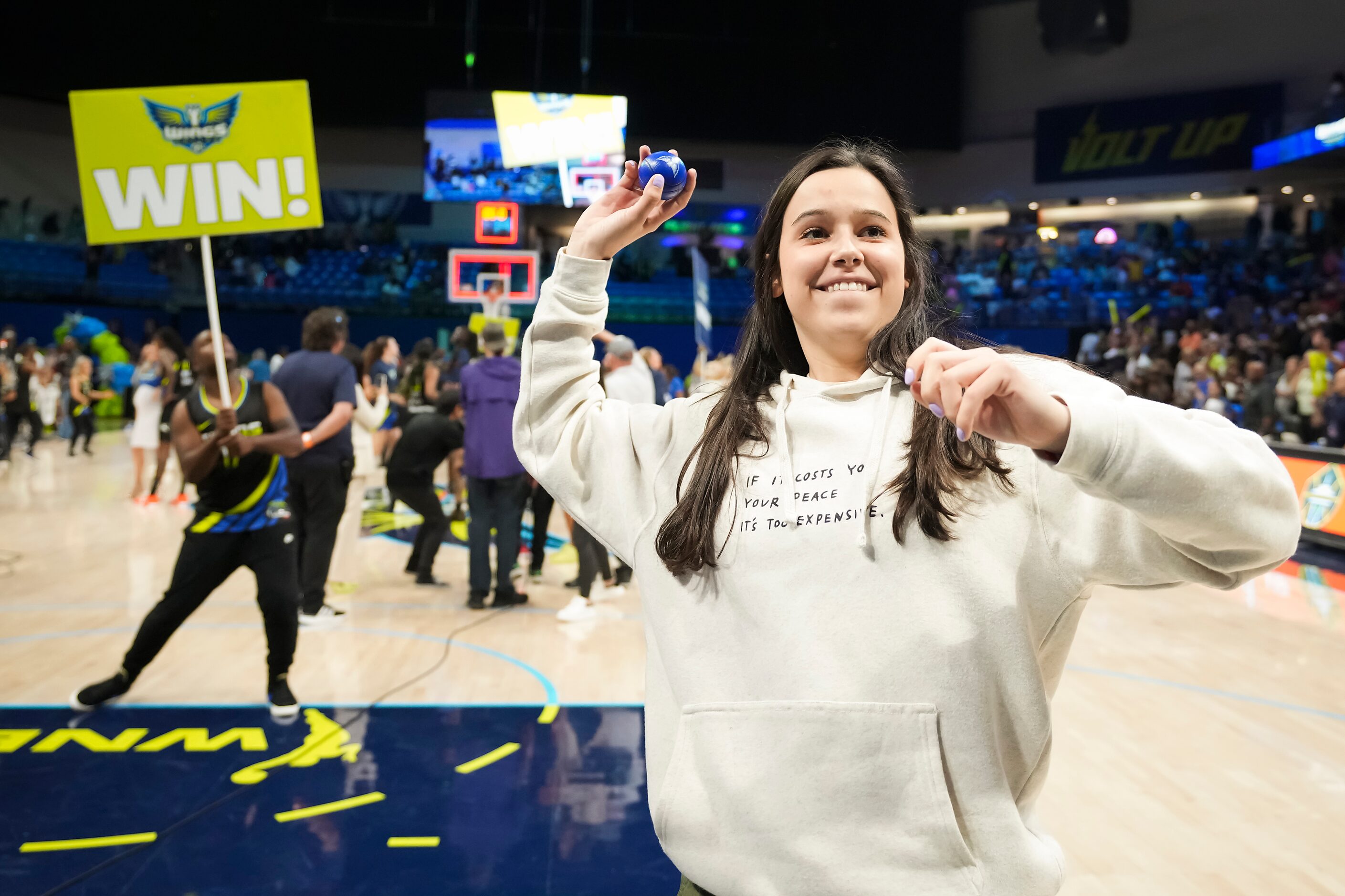 Dallas Wings guard Lou Lopez Sénéchal tosses a ball to the crowd after a victory over the...