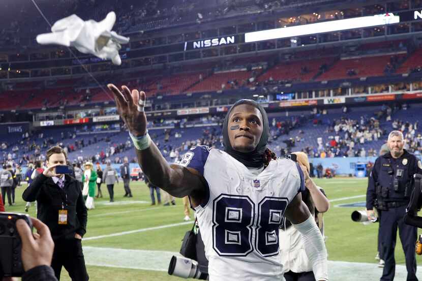 Dallas Cowboys wide receiver CeeDee Lamb (88) tosses a towel to fans after an NFL game...