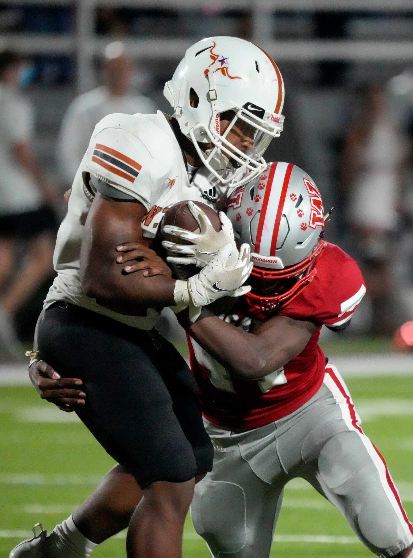 Woodrow Wilson senior linebacker Isiah Morgan, right, tackles W.T. White Elijah Edwards (20)...