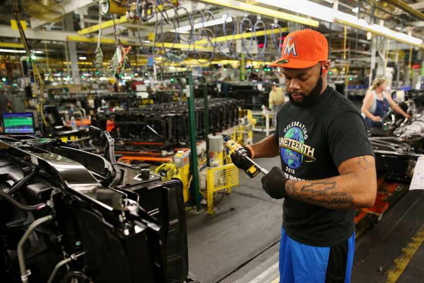 Mark David works on the front of a vehicle inside the General Motors general assembly plant...