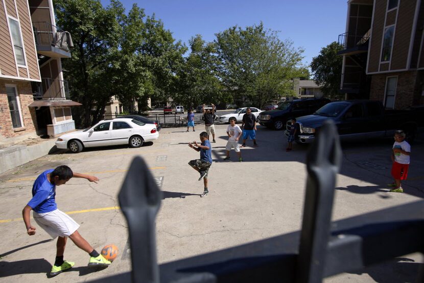 A group of children play soccer near The Ivy Apartments in October 2014. 