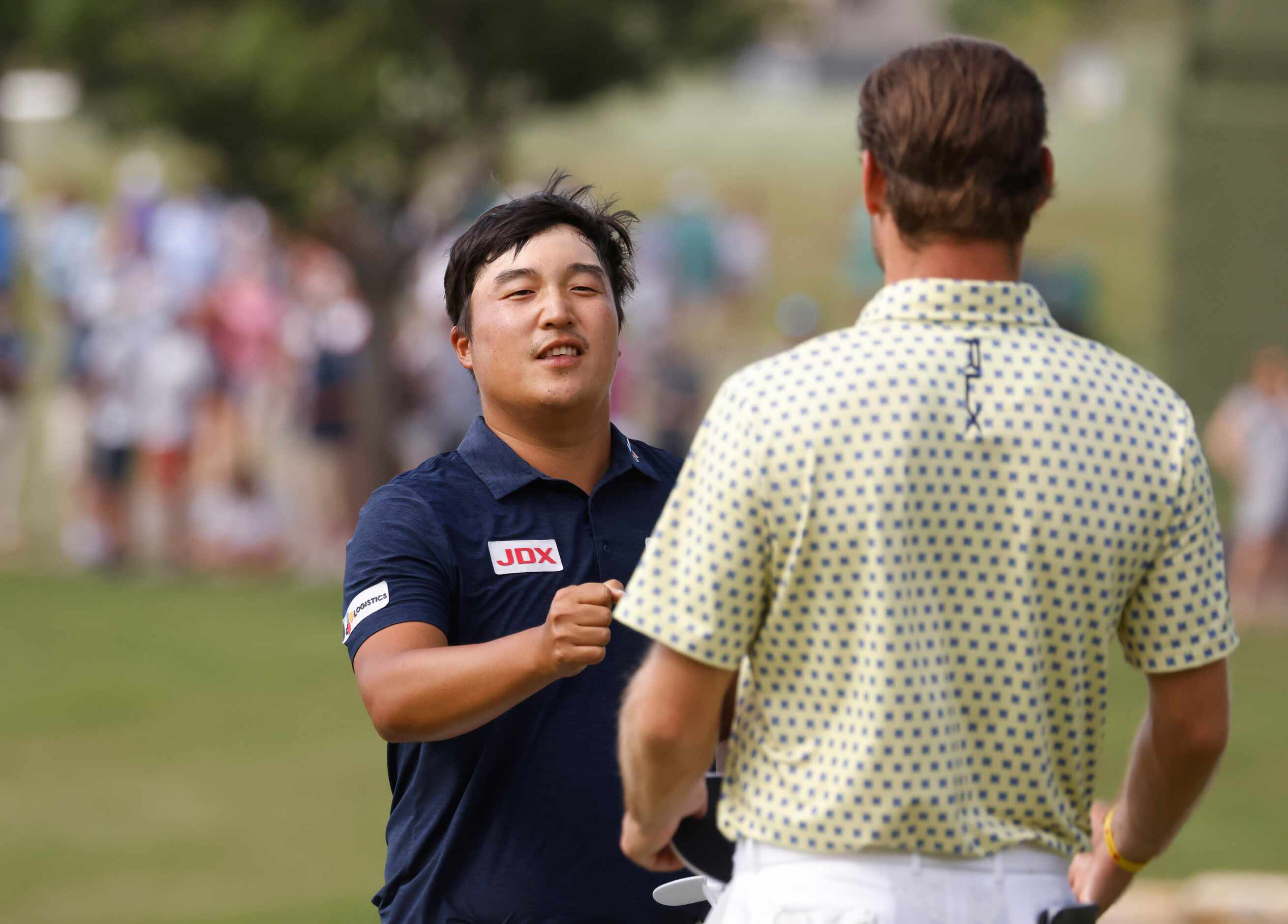 Kyoung-Hoon Lee bumps fists with Doc Redman after finishing on the 18th hole during round 3...