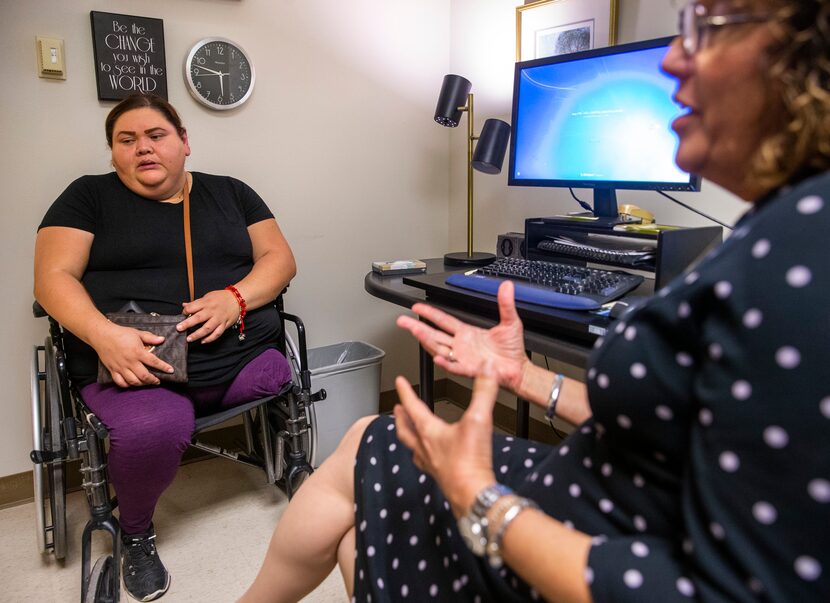 Guadalupe Vergara, 40, from Oak Cliff listens to Ana Castellanos talk about her experience...