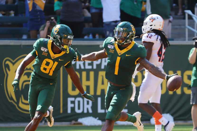 Baylor cornerback Grayland Arnold, right, celebrate with wide receiver Tyquan Thornton,...