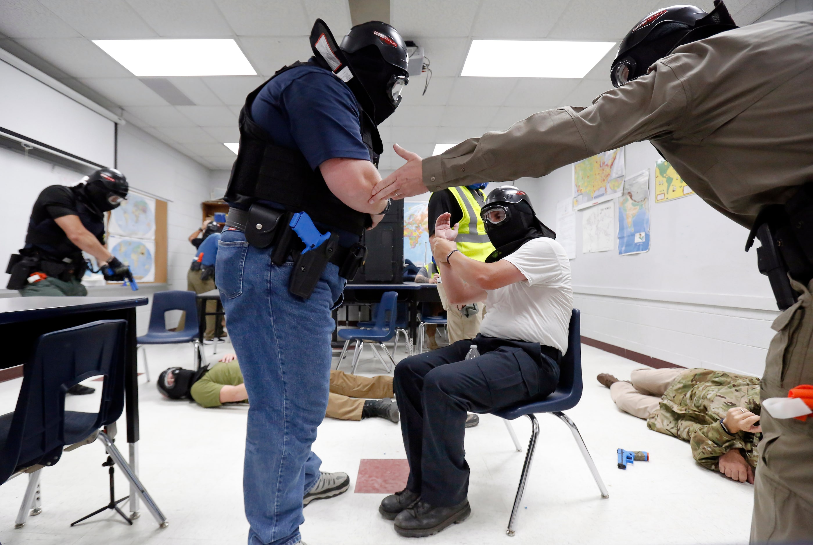 Athens Police Officers Travis Murdoch (left), Roger Keith (center) and Texas DPS Trooper...