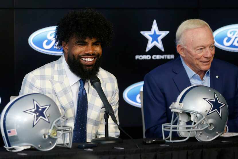 Dallas Cowboys running back Ezekiel Elliott (21) smiles as he sits next to Dallas Cowboys...