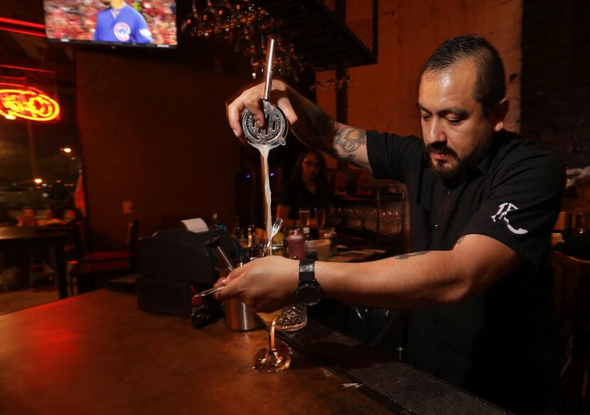 Bartender Jesse Sanchez mixes a drink off a menu that features dozens of bourbons, ryes and...