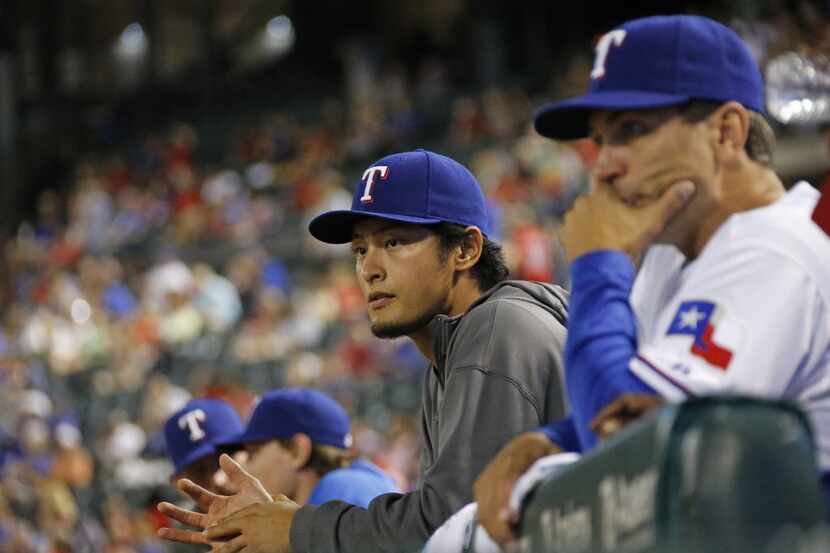Texas pitcher Yu Darvish watches from the dugout during the Tigers' 8-2 win during the...