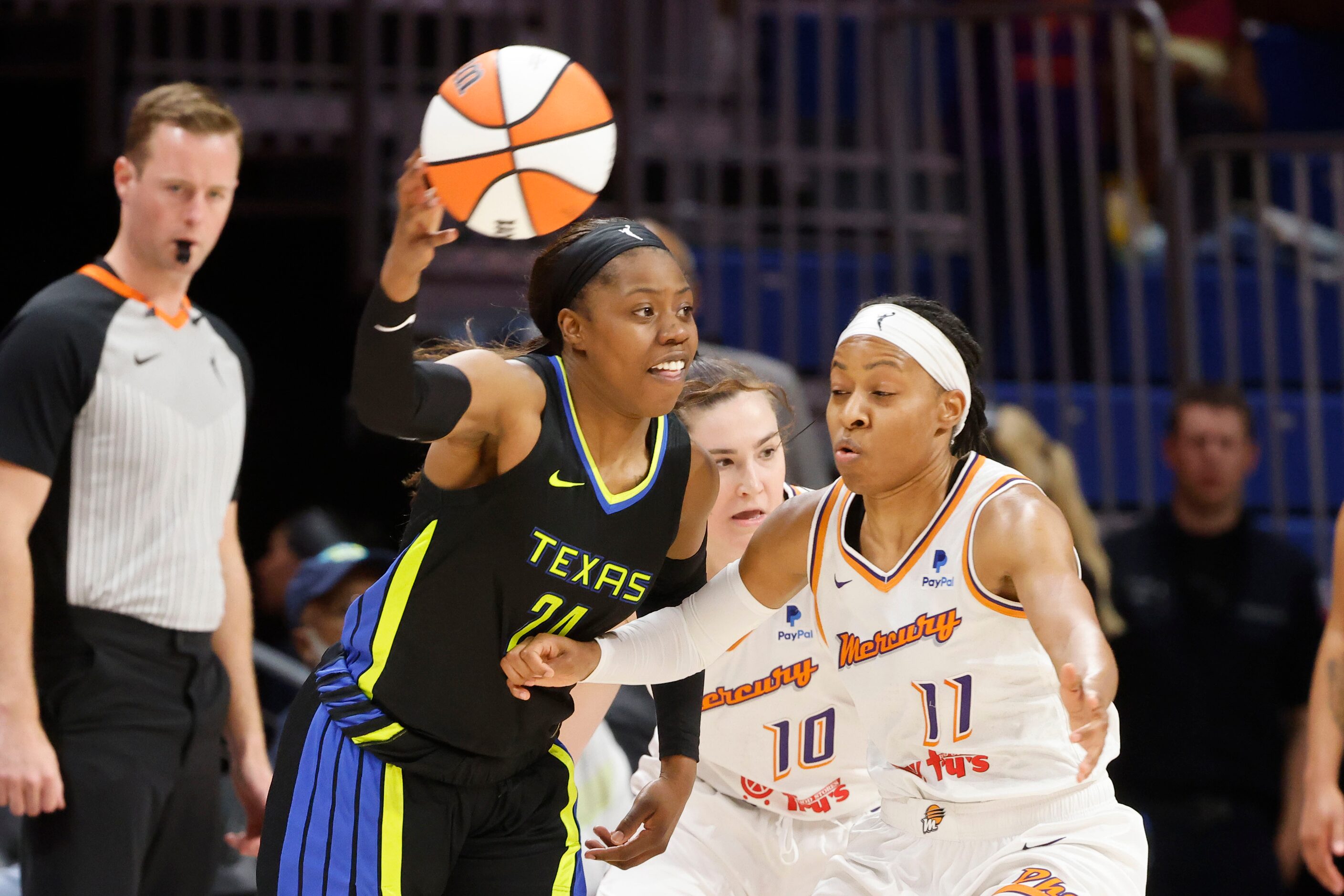 Dallas Wings guard Arike Ogunbowale (24) passes the ball past Phoenix Mercury center Megan...