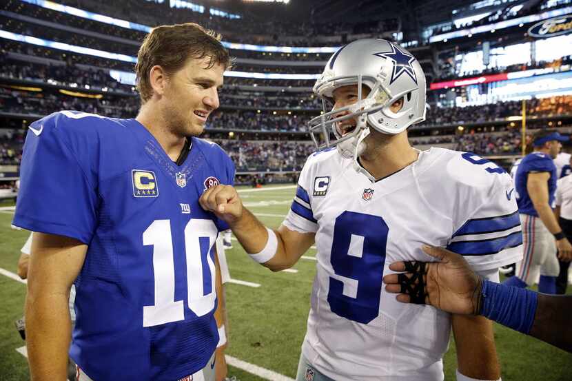 Dallas Cowboys quarterback Tony Romo (9) and New York Giants quarterback Eli Manning (10)...
