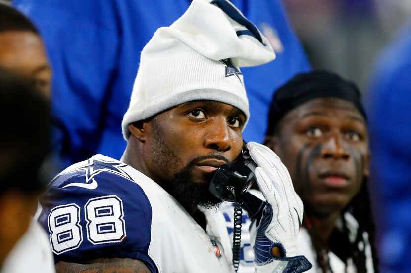 With his stocking hat on, Dallas Cowboys wide receiver Dez Bryant (88) receives a call from...