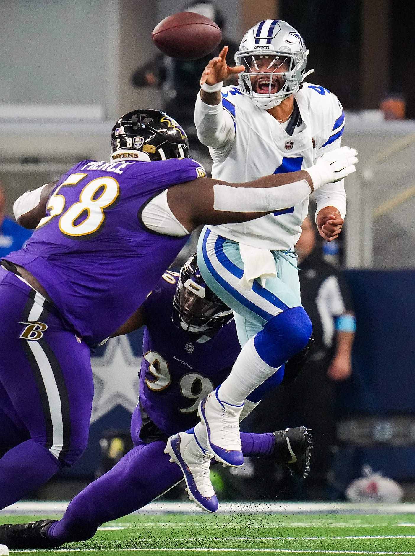 Dallas Cowboys quarterback Dak Prescott (4) gets off a pass under pressure from Baltimore...