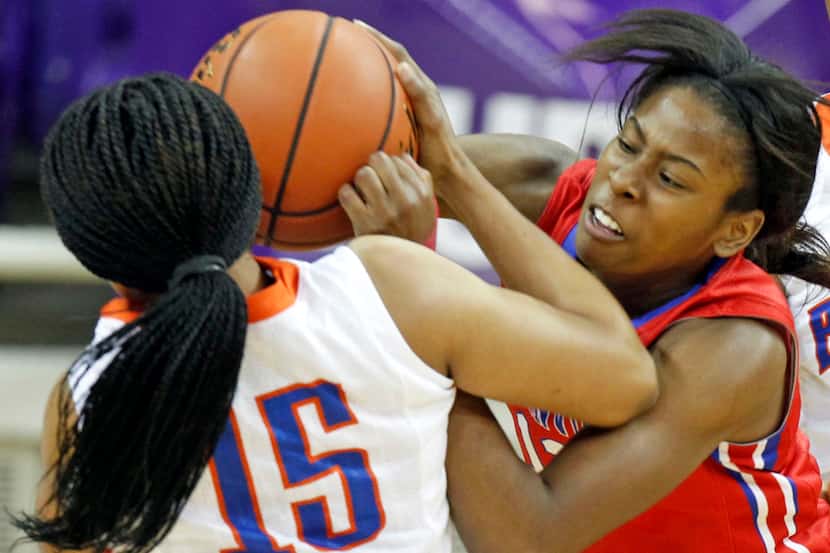 Arlington Bowie's Niclole Iloanya (15) and Duncanville's Ariel Atkins (12) fight for the...