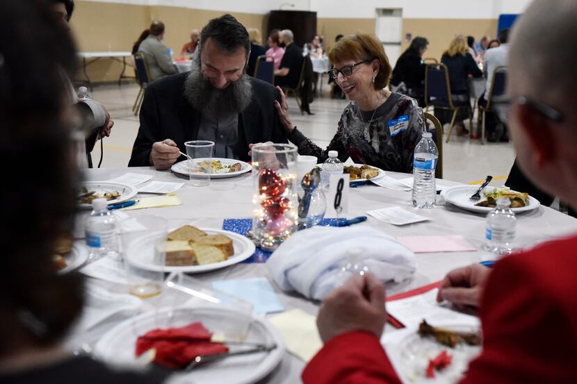 Lonna Rae Silverman (right) of the Temple Shalom steering committee reacts with laughter...