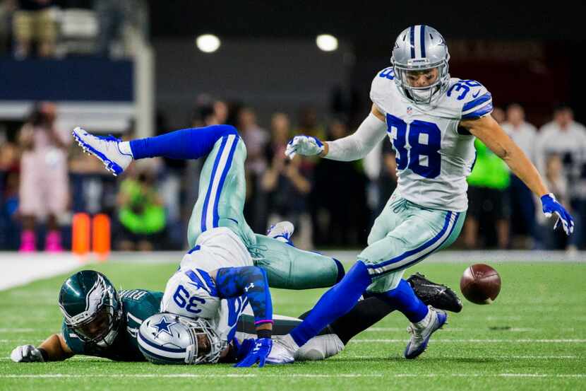 Dallas Cowboys cornerback Brandon Carr (39) and strong safety Jeff Heath (38) prevent a...