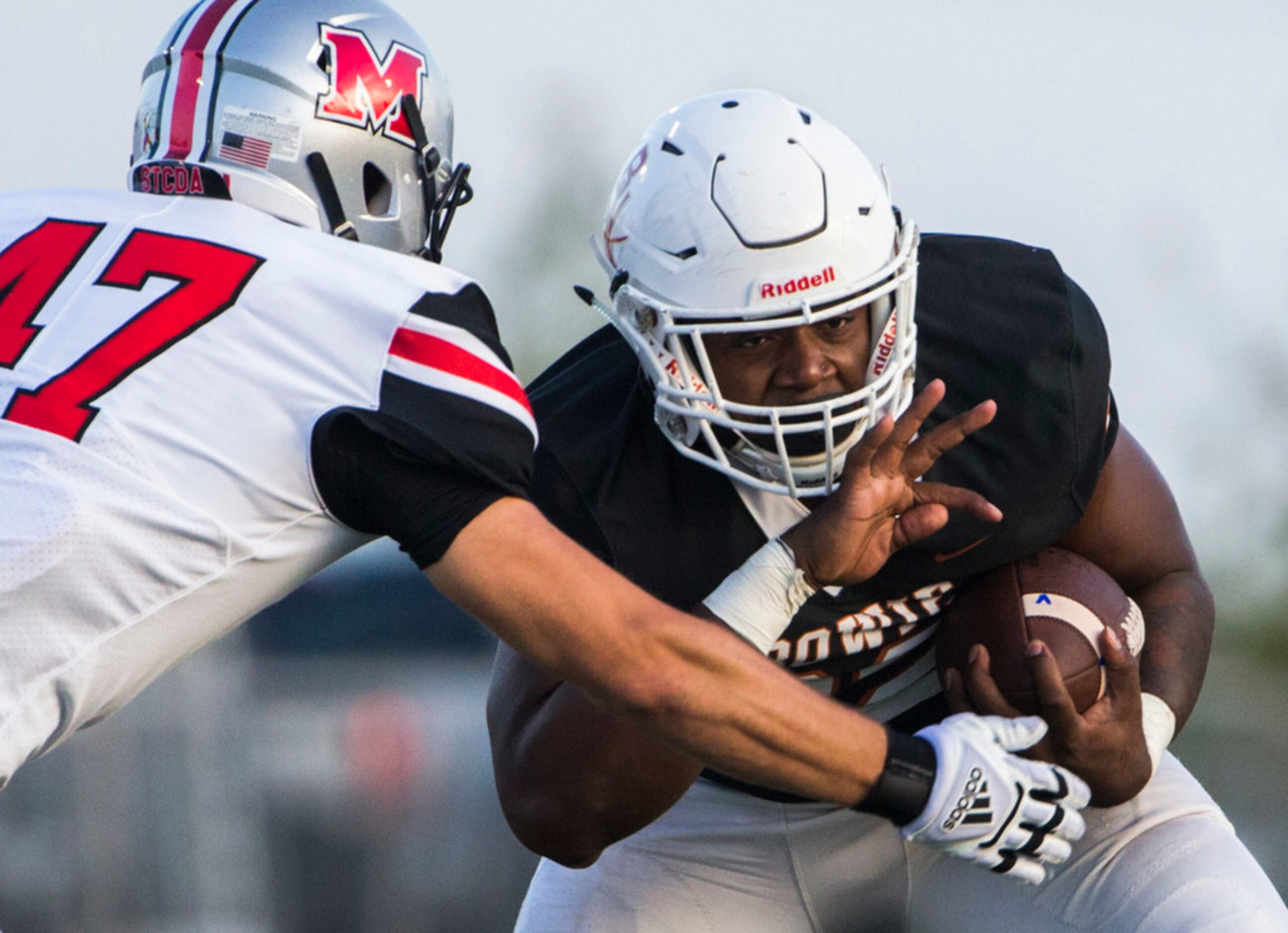 Arlington Bowie running back Marsaillus Sims (32) breaks a tackle by Flower Mound Marcus...