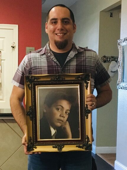 Jamie Contreras holding a photo of Jose "Pepe" Villegas as a child. Contreras, a childhood...