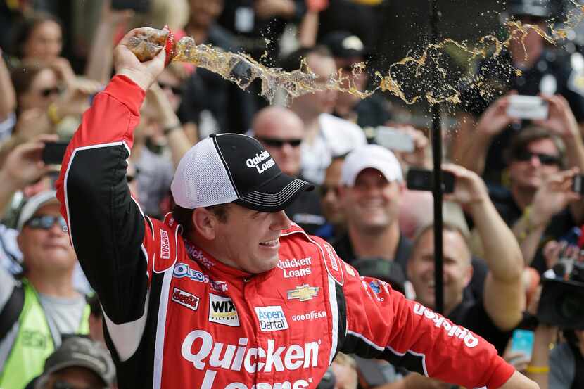 Sprint Cup Series driver Ryan Newman celebrates after winning the Brickyard 400 auto race at...