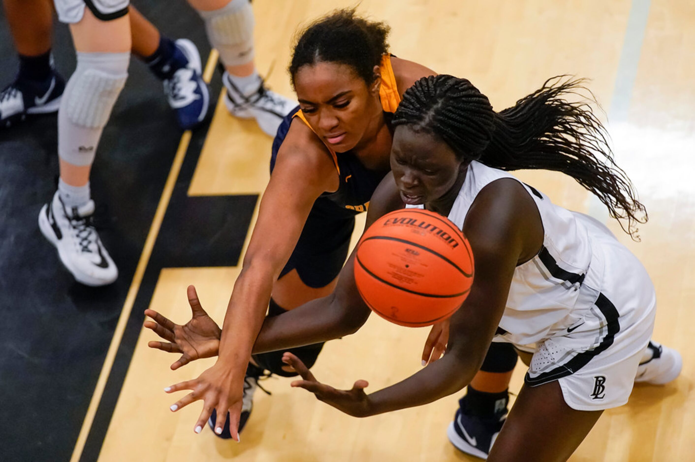 Bishop Lynch's Ayen Angoi (right) fights for a rebound against Prestonwood Christian forward...