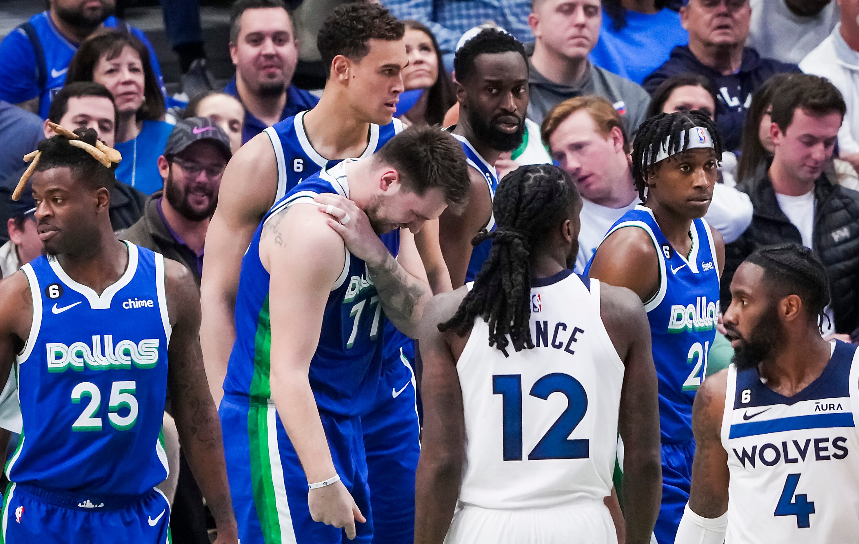 Dallas Mavericks guard Luka Doncic (77) grabss his shoulder after being fouled during the...