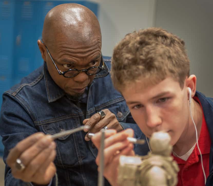 Sculptor Emmanuel Gillespie in the studio at The Winston School with student Chris Bird on a...