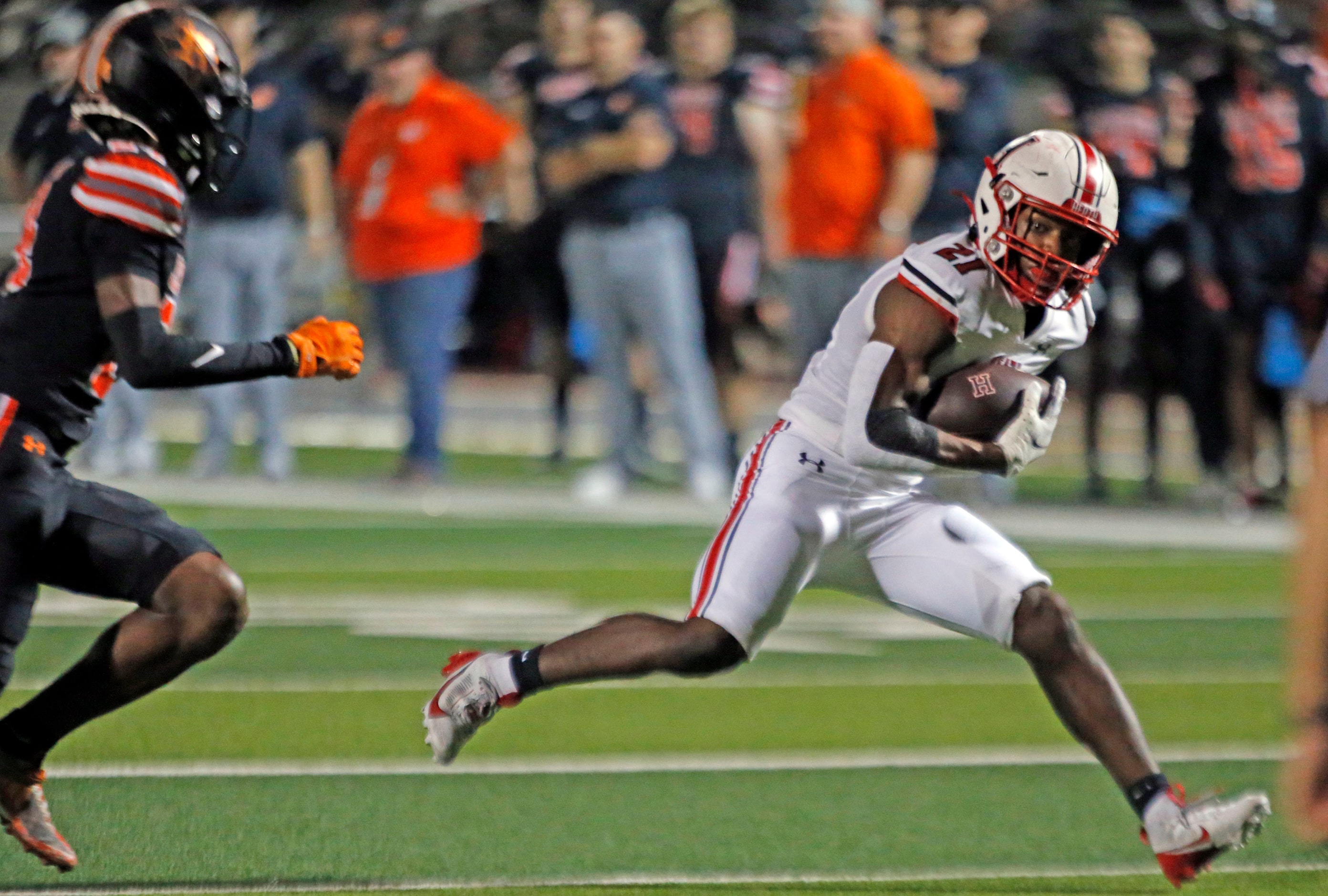 Rockwall Heath High RB Ashton Bradford (21) tries to pick his way through the Rockwall High...