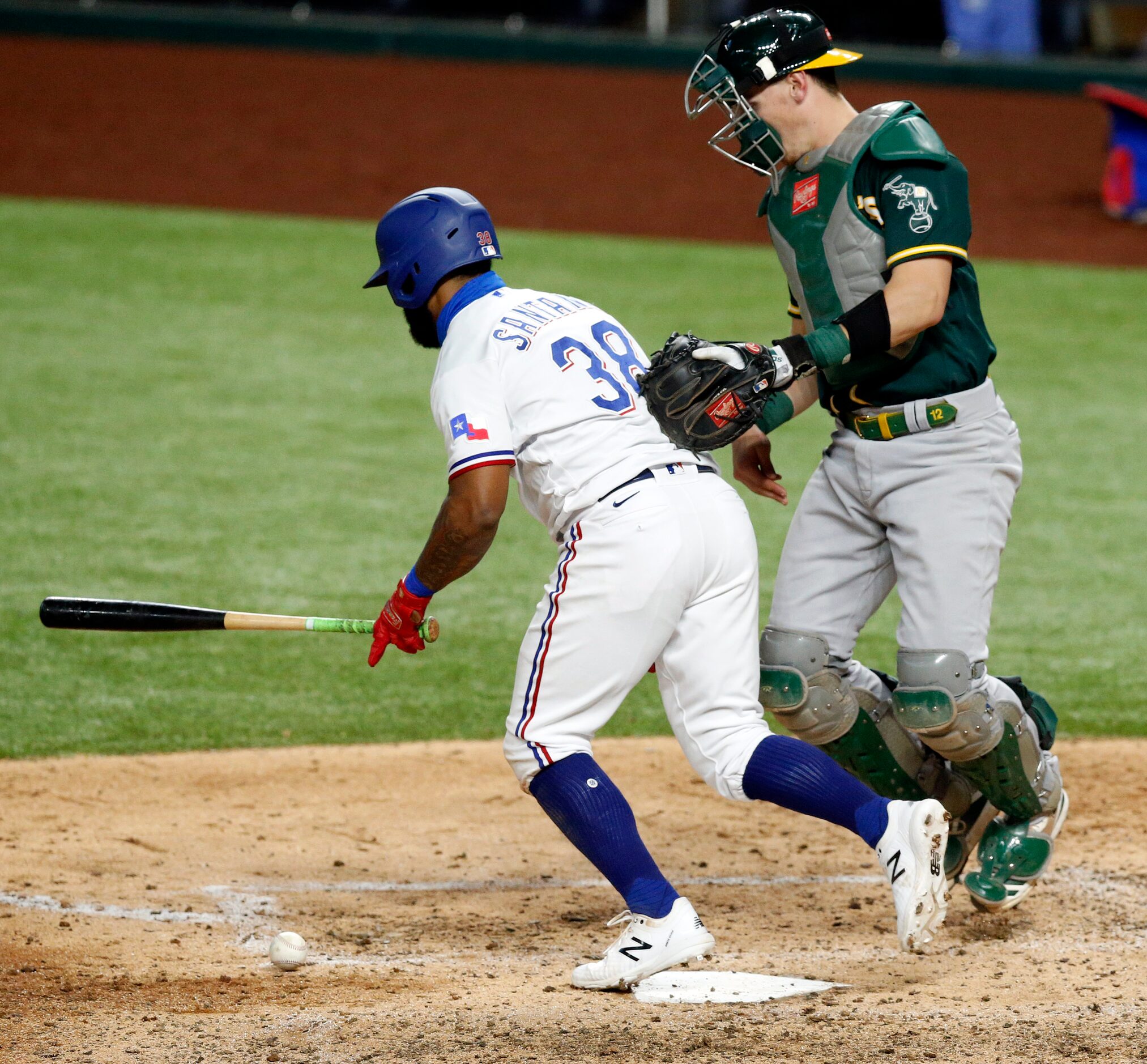 Texas Rangers fist baseman Danny Santana (38) hits the ball short of the plate as Oakland...