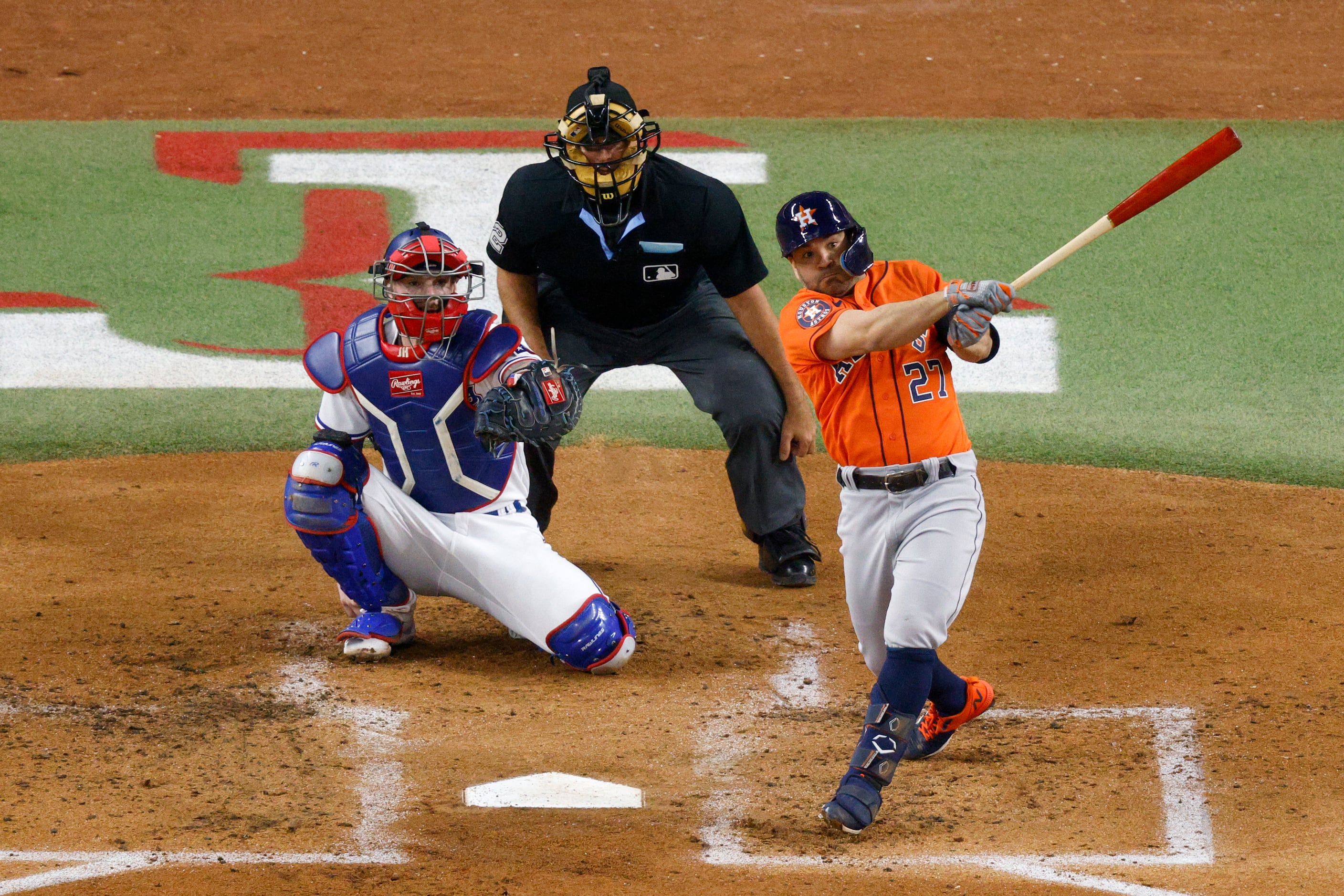 Houston Astros' Mauricio Dubon looks at his bat as he waits to hit