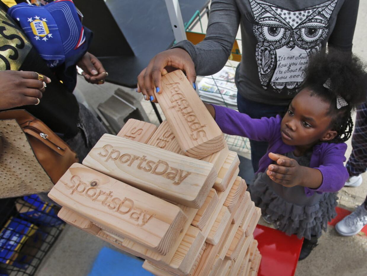 Anyia Luo tries her hand a Jenga at a booth at the 7th Annual State Farm Festival de Los...