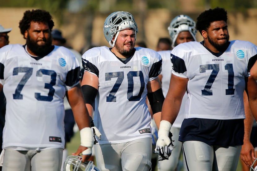 From left, Dallas Cowboys center Joe Looney (73), guard Zack Martin (70) and offensive...