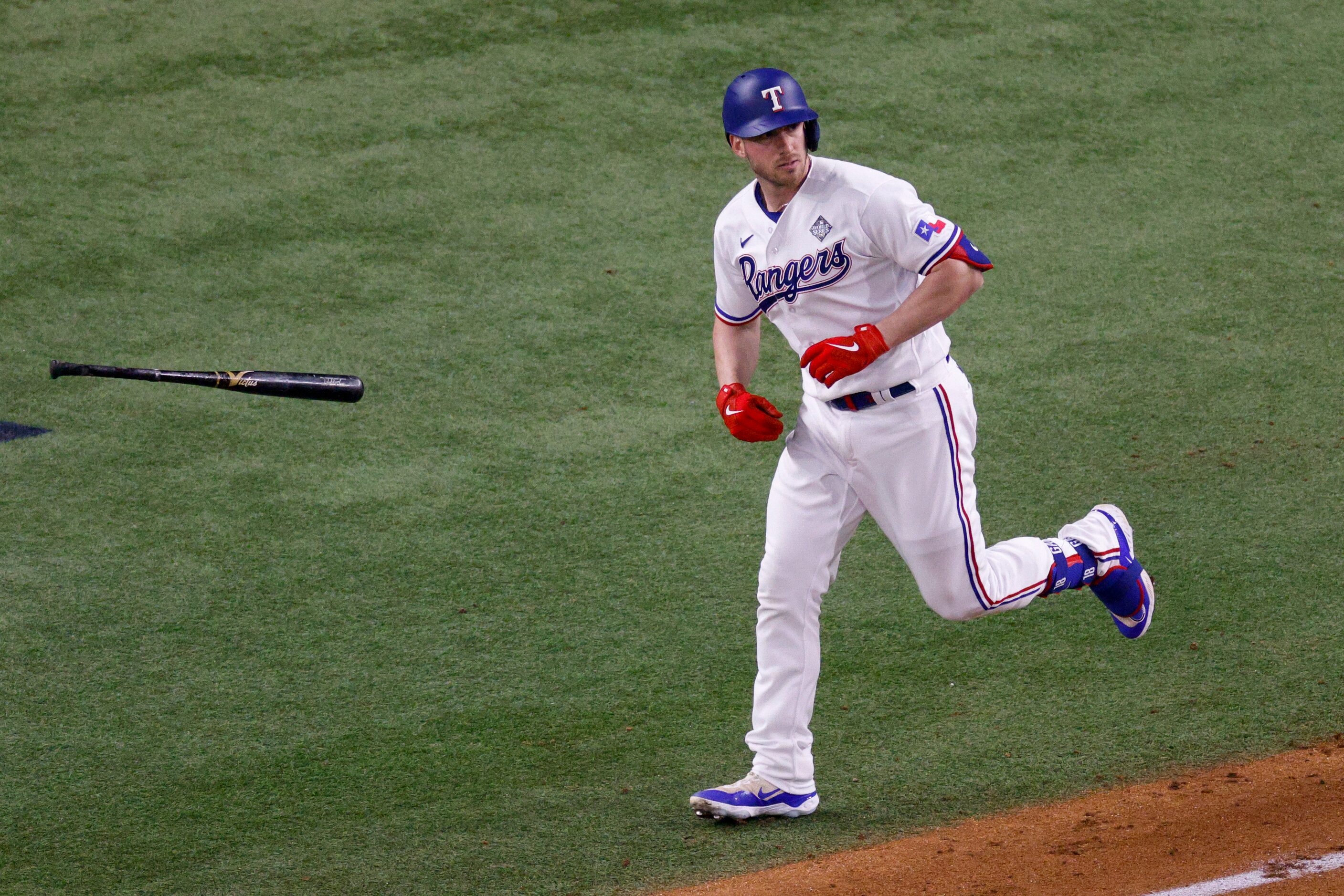 Texas Rangers catcher Mitch Garver (18) flips his bat after hitting a home run off Arizona...