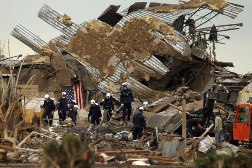Crews combed through debris at Plaza Towers Elementary School in Moore, Okla., on Tuesday....