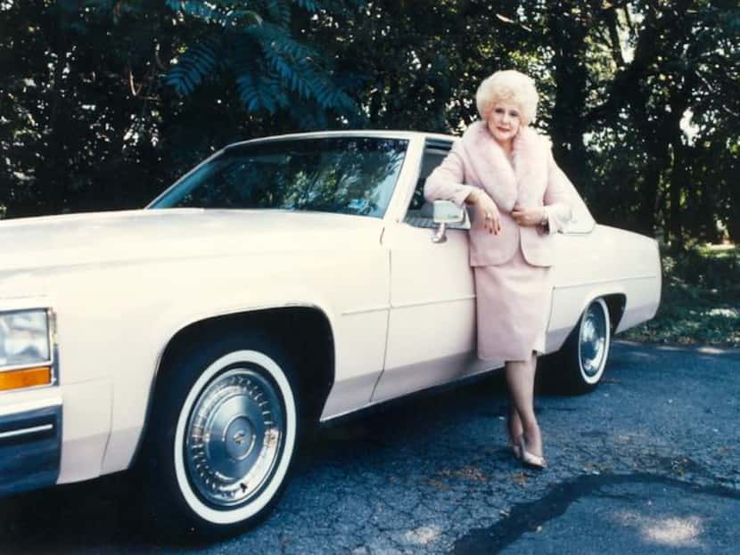 
Mary Kay founder Mary Kay Ash stands next to one her iconic pink Cadillac Fleetwoods.
