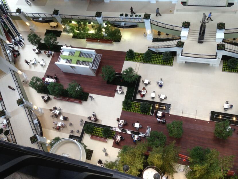 Instead of the old ice rink, the bottom of the atrium has a garden, seating areas and...