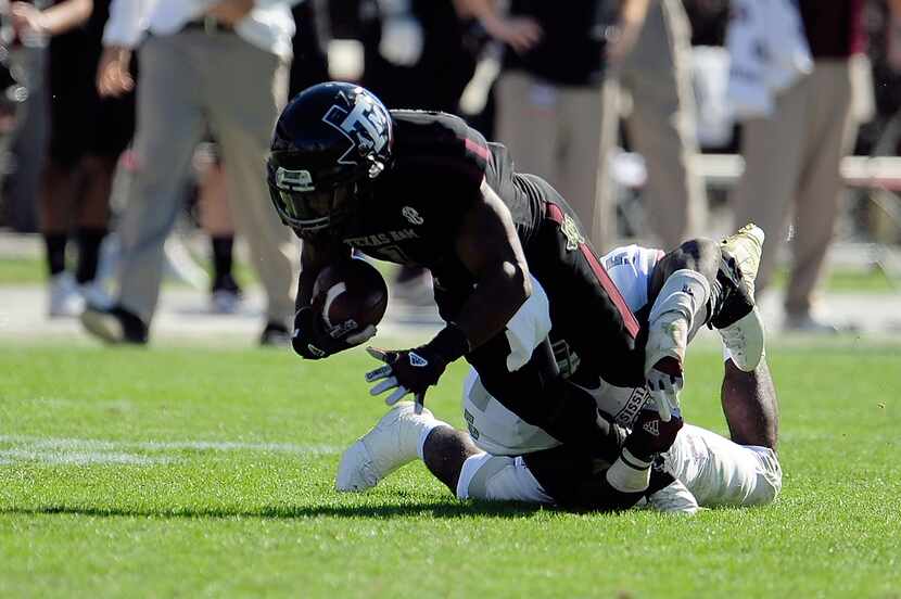 STARKVILLE, MS - NOVEMBER 03:  Ben Malena #1 of the Texas A&M Aggies is brought down by...
