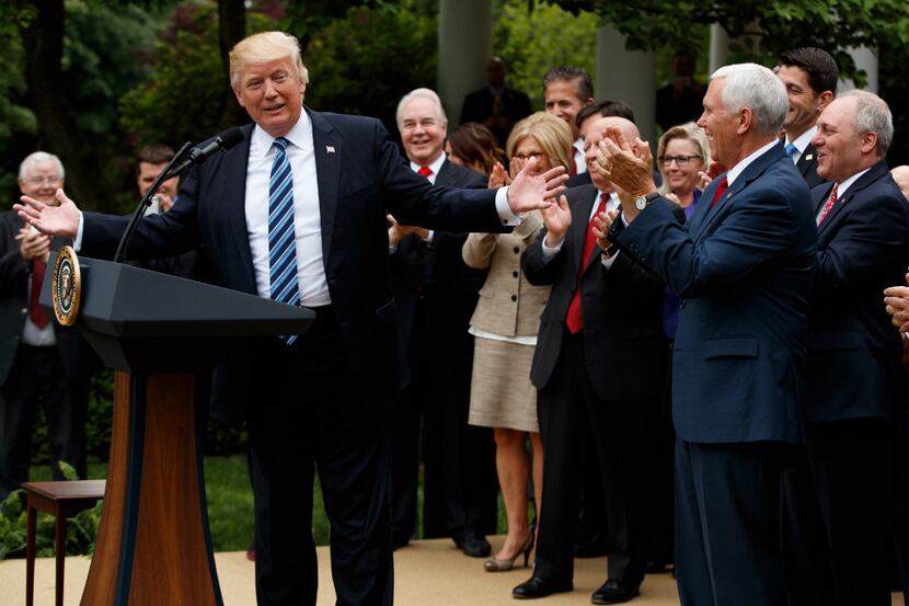 President Donald Trump, accompanied by GOP House members, speaks in the Rose Garden of the...