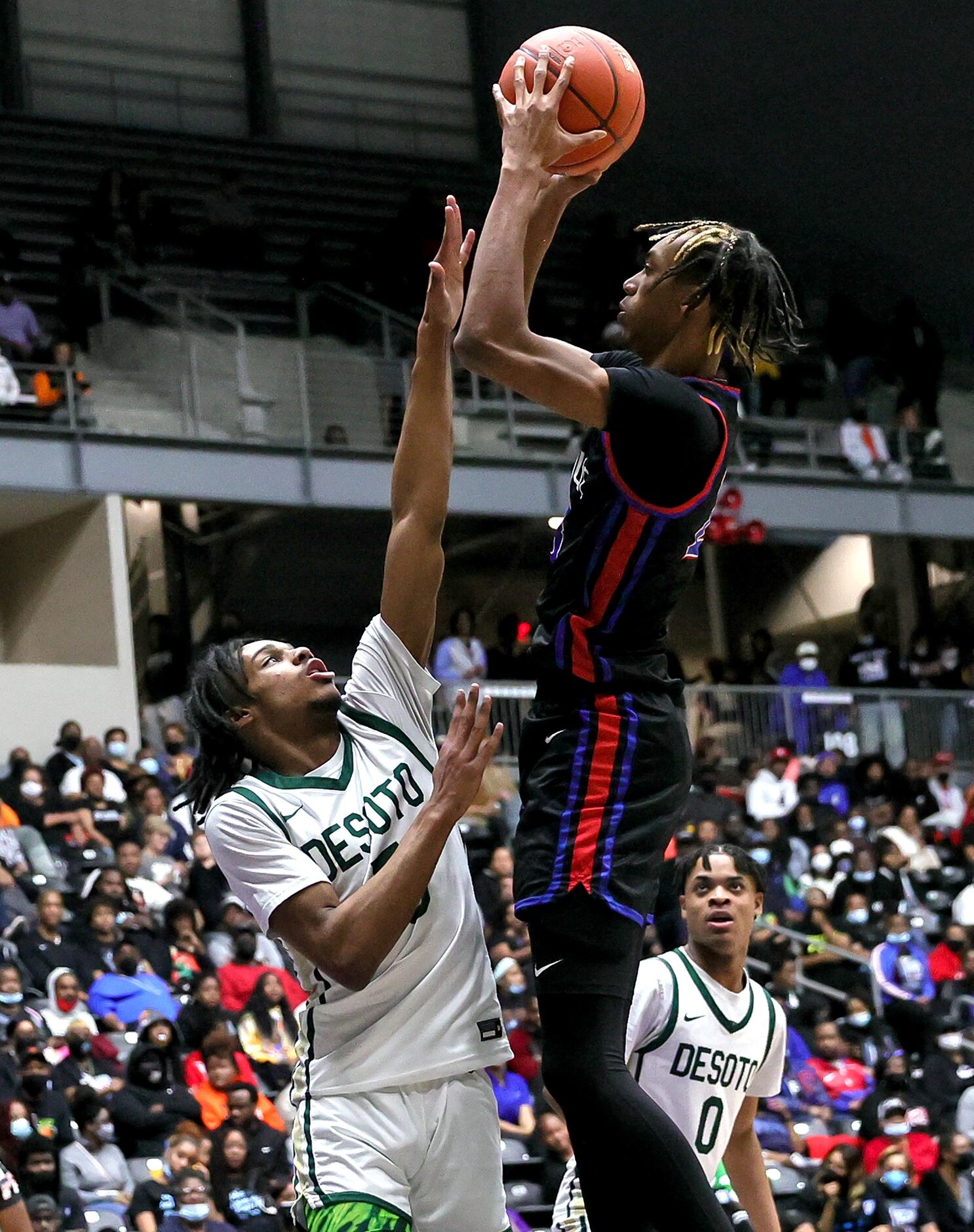 Duncanville forward Cameron Barnes (R) tries to get a shot off over DeSoto forward Ahmir...