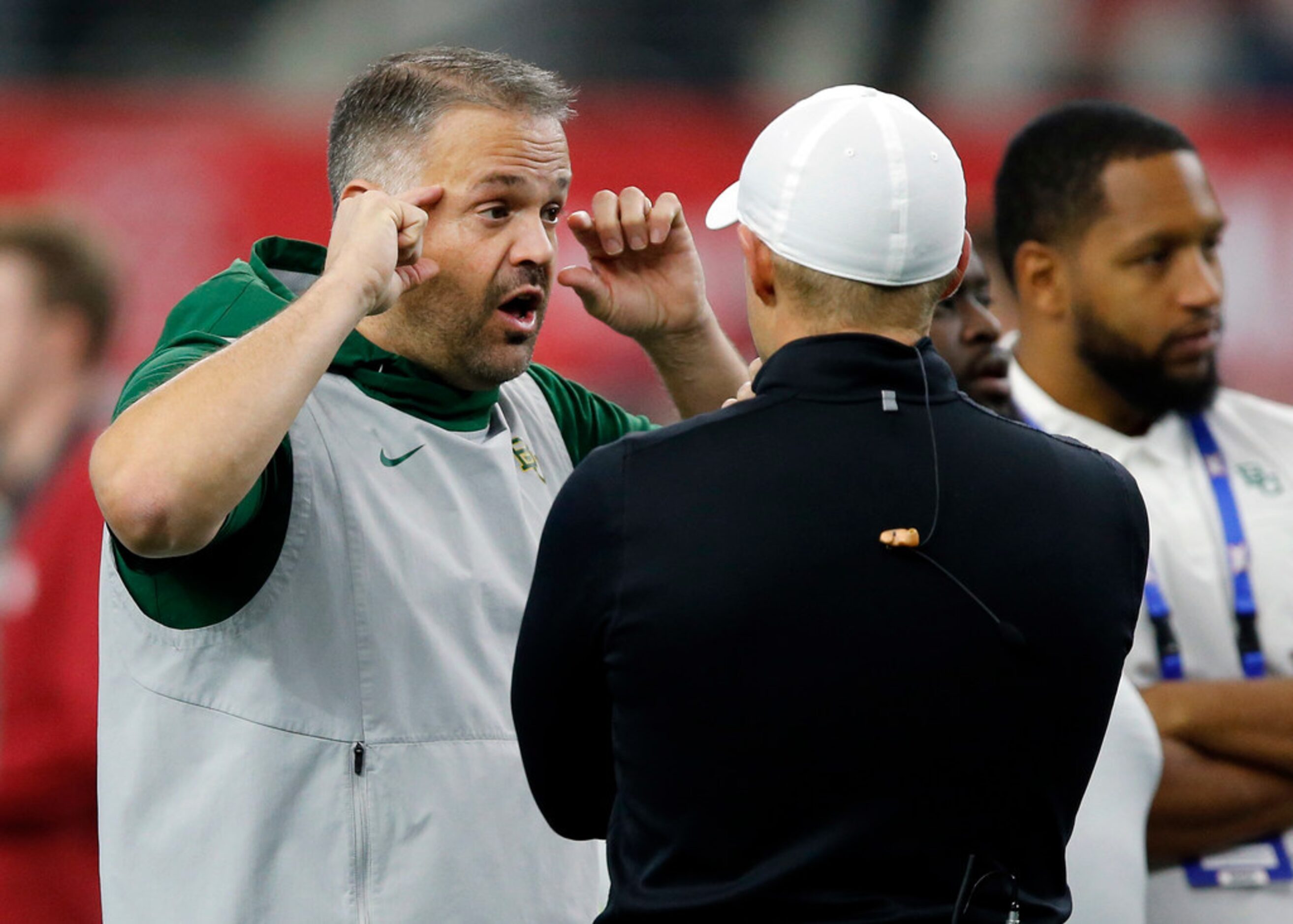 Baylor Bears head coach Matt Rhule visits with an official during warm ups before facing the...