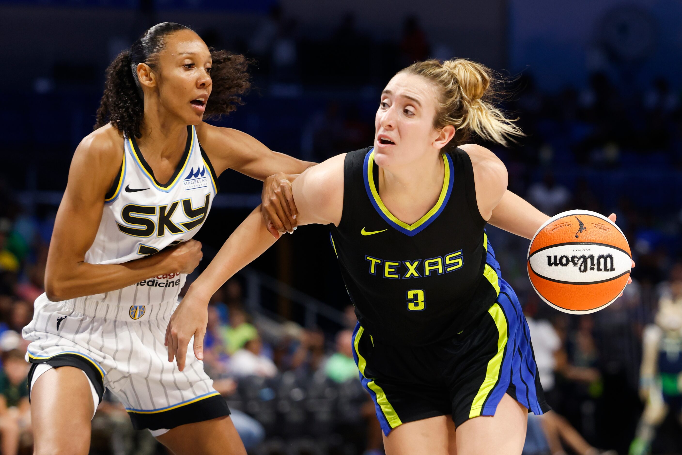 Dallas Wings guard Marina Mabrey, right, dribbles past Chicago Sky guard Rebekah Gardner...