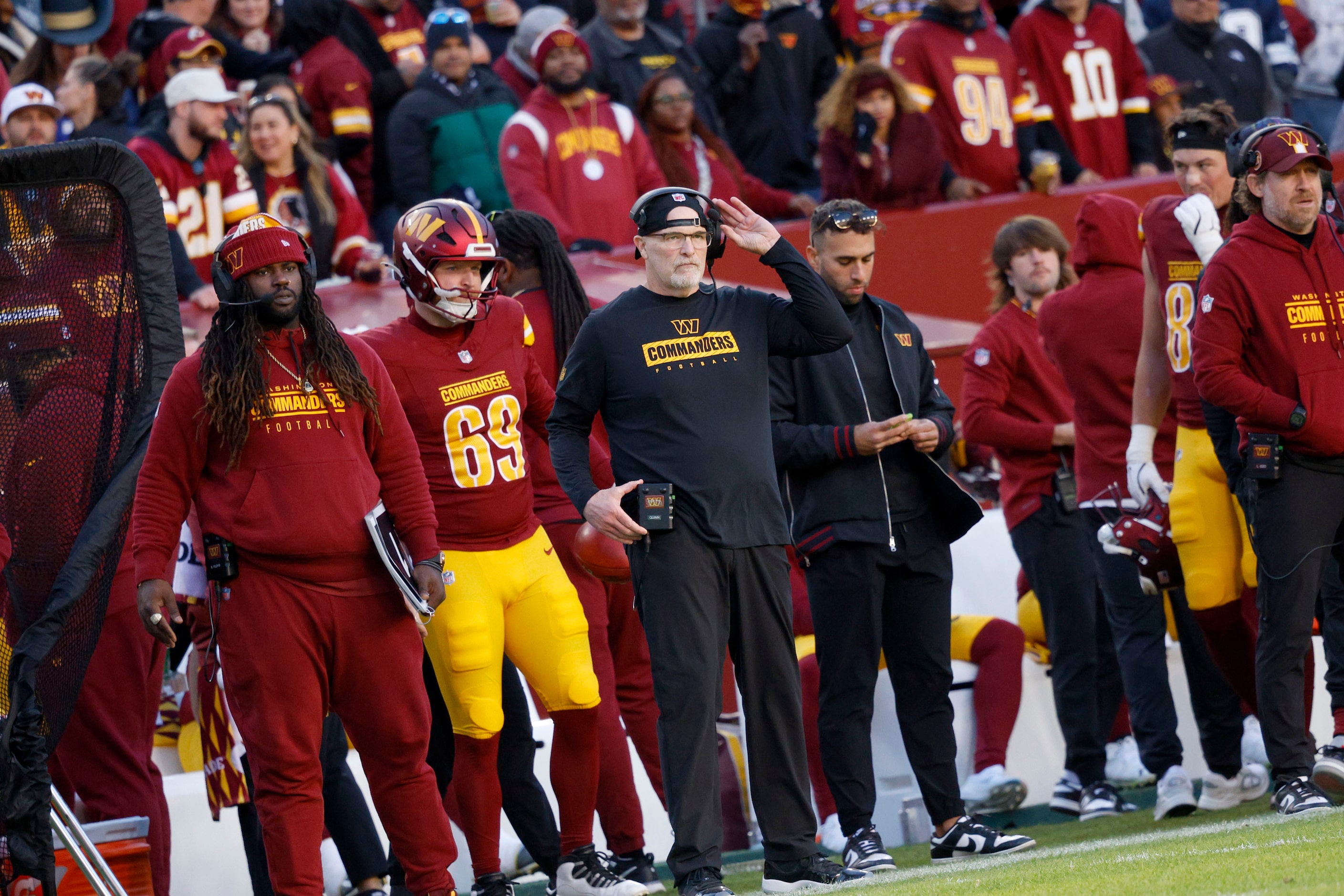 Washington Commanders head coach Dan Quinn , center, watches his players in the second half...